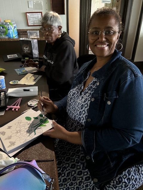 Smiling woman during painting