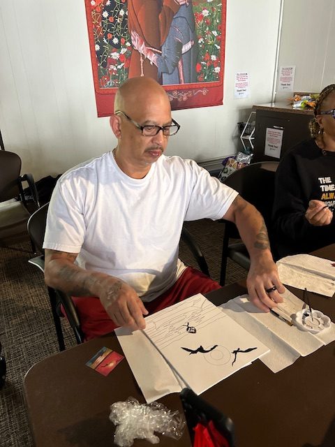 Man arranging his artwork