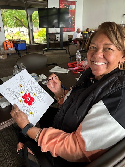 Woman painting a red flower