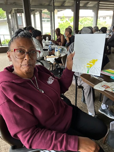 Woman painting a yellow flower
