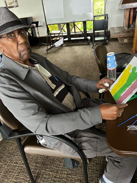 Man with a painting of three colored stripes