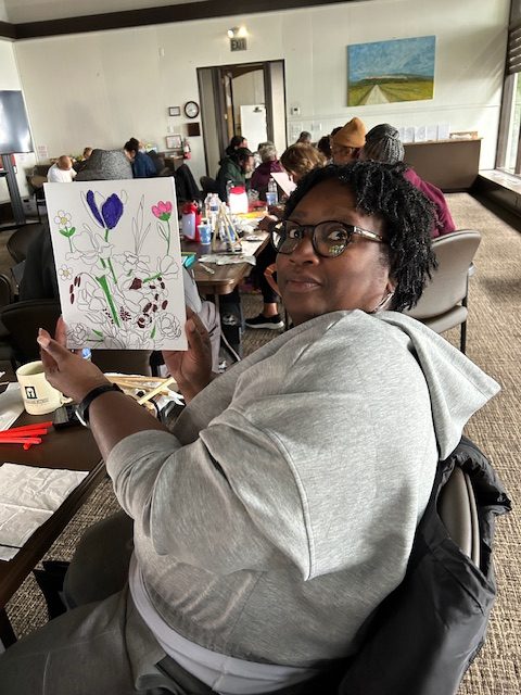 Women holding up her watercolor